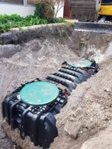 Inspecting a septic system, pumping out waste, and ensuring functionality as part of Orlando septic tank service.